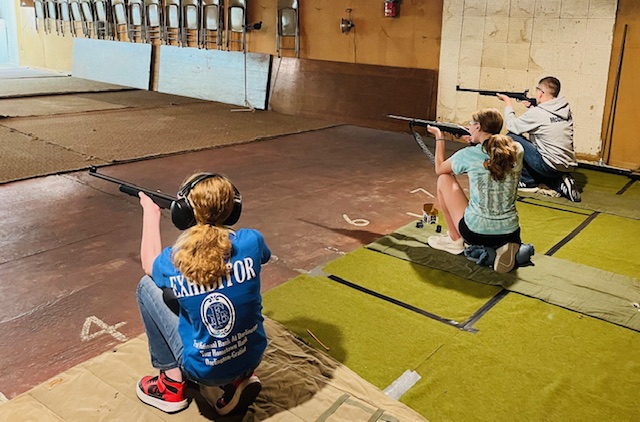 Youth practice shooting .22 rifle and .22 pistol